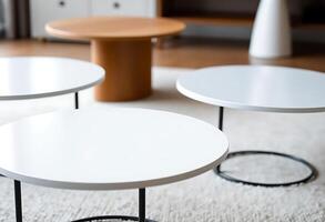 group of three tables sitting on top of a white rug photo