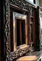 couple of frames sitting on top of a wooden shelf photo