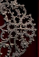 metal object with intricate designs on it photo