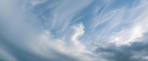 blue sky with clouds and a plane in the distance photo