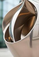 close up of a metal object with a building in the background photo