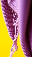 close up of a purple cloth with a yellow background photo