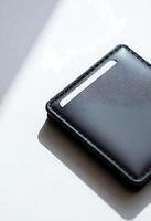 black card holder sitting on top of a white table photo