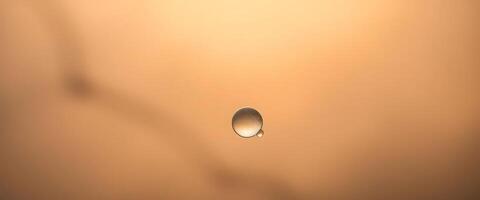 drop of water sitting on top of a brown surface photo