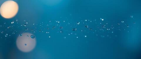 close up of water droplets on a blue surface photo