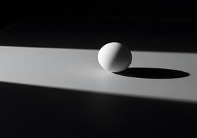 An egg sitting on a table with the light shining on it photo