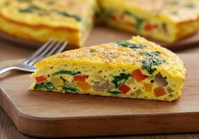 A quiche on a cutting board with a fork photo