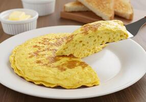 A plate with a slice of omelet and toast on it photo