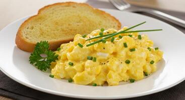 A plate with scrambled eggs and toast photo