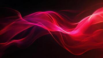 Beautiful and vivid waves of red and magenta light dance across a dark background. photo