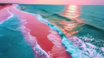 Vibrant aerial view captures a stunning pink beach meeting turquoise ocean waves during a sunset. photo