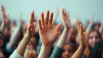 Many hands raised up high in unison, representing a shared sentiment, and support for something. photo