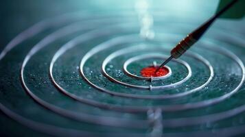 A dart is perfectly placed on the bullseye of a textured target, ready to hit its mark. photo