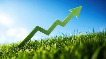 An upward pointing green arrow, symbolizing growth and progress, in a field of grass. photo
