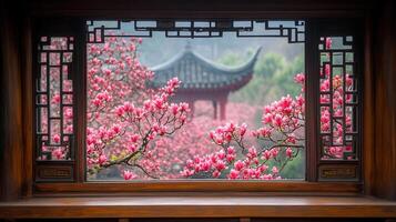 A beautiful window frame showcases a serene view of a vibrant garden with blossoming pink magnolias. photo