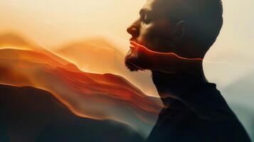 A contemplative profile of a man merges with layered, warm-toned abstract visuals, creating a serene scene. photo