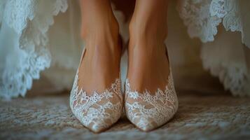 A close-up captures a bride's lace wedding shoes, ready for the special day of her life. photo