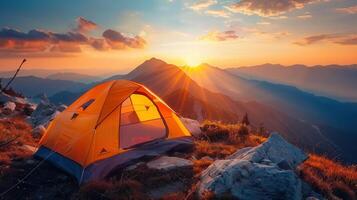 Camping tent on a mountain at sunrise, capturing a breathtaking scenic outdoor experience. photo