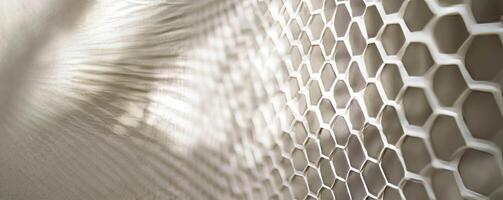 Translucent hexagonal mesh texture on bright background for modern design photo