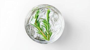 Refreshing rosemary sprigs in clear glass bowl with ice cubes for culinary and aesthetic design photo