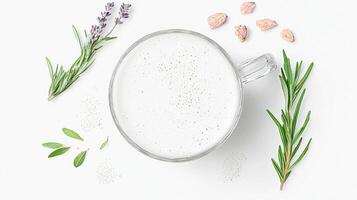 Herbal tea latte with fresh herbs in a glass mug photo