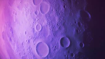 Violet moon texture with chaos abstract crater patterns for background design photo