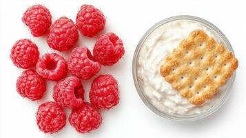 Fresh raspberries with cream cheese dip and cracker arrangement for snack inspiration photo