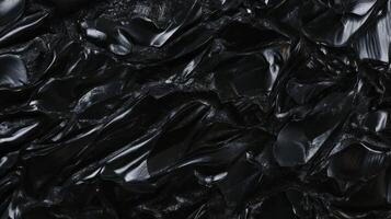 Abstract chaotic black texture with moon-like craters for creative design photo