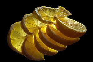 The Sliced Lemon Displaying Translucency Backlit on a Black Background Creating a Beautiful Artistic Effect photo
