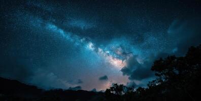 The milky way over the trees and mountains photo