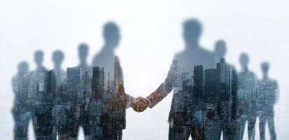 Business people shaking hands in front of cityscape photo