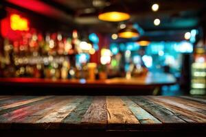 Wooden table top in bar with blurred lights photo