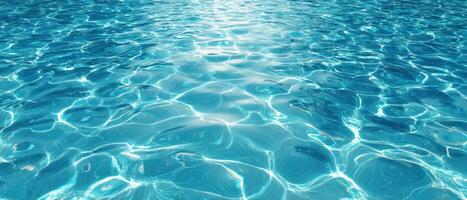 A pool with blue water and sunlight photo