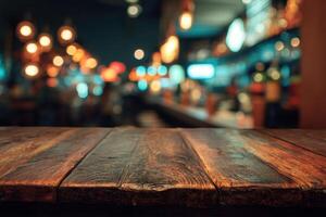 A wooden table in a bar with lights in the background photo