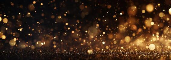 Golden glitter particles on black background photo