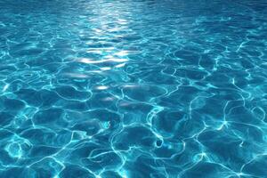 Blue water in a swimming pool with sunlight shining on it photo