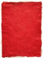 A red paper with a piece of paper on it photo
