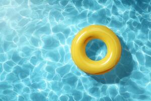 An inflatable yellow life ring floating in a pool photo