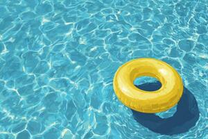 A yellow inflatable ring floating in a pool photo