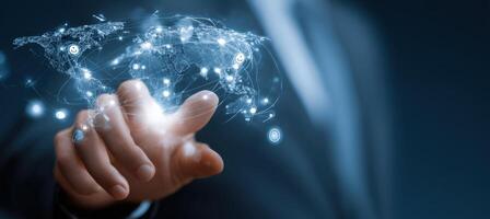 Businessman hand holding a world map with network connections photo