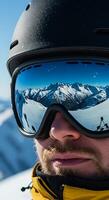 A man wearing a helmet and goggles on a snowy mountain photo