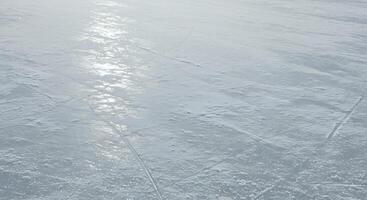 Ice skating rink with snow on the surface photo