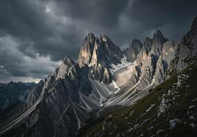 A mountain range is shown under a cloudy sky photo