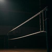 A volleyball net sits in the middle of a gym photo