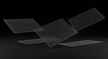 Three pieces of clear plastic on a black surface photo