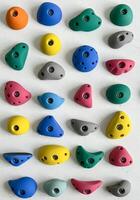 A variety of climbing rocks are arranged in a row photo