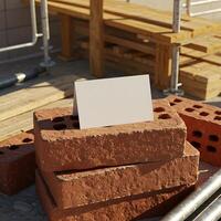 A stack of bricks with a blank card on top photo
