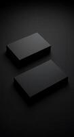 Two black boxes on a dark surface photo
