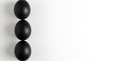 Three black eggs on a white surface photo
