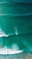 A person is riding a surfboard in the ocean photo